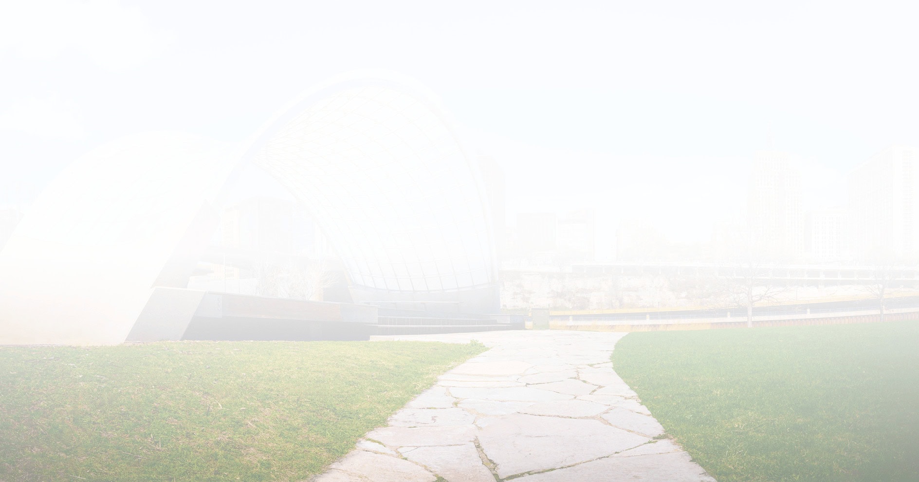 A vibrant person in business attire walks energetically past the Nashville Soldiers and Sailors Memorial amidst a bustling cityscape.