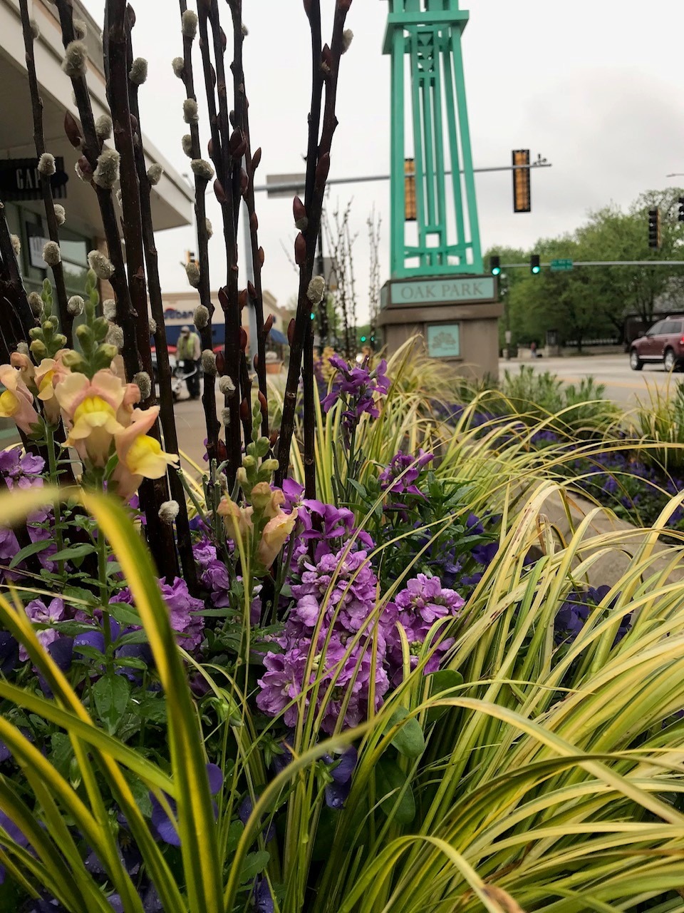 Vibrant flowers in the foreground, with a tall green structure labeled 